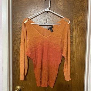 This beautiful orange shirt is by IINC the size is an extra large.